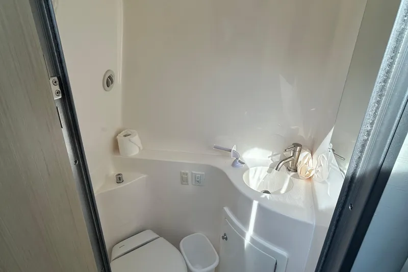Slide: The Image of 2024 Regal 26 XO boat bathroom with compact sink and toilet. - 25