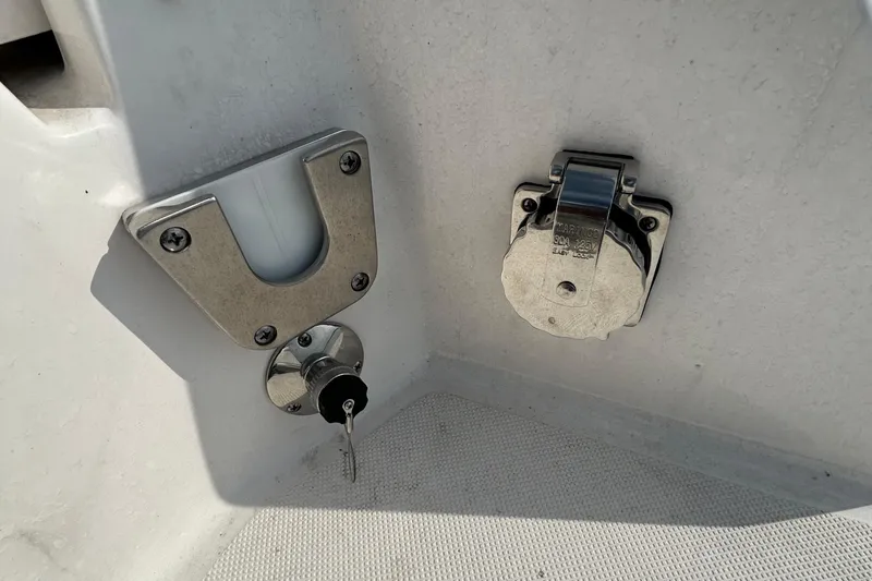 Slide: The Image of 2024 Regal 26 XO boat detail showing key lock and power outlet. - 27