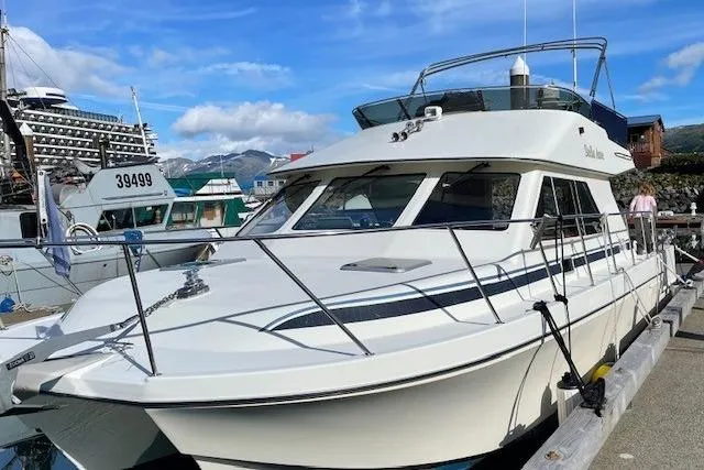 The Image of 2003 Zeta 36 boat docked at marina with scenic mountain backdrop. - 0