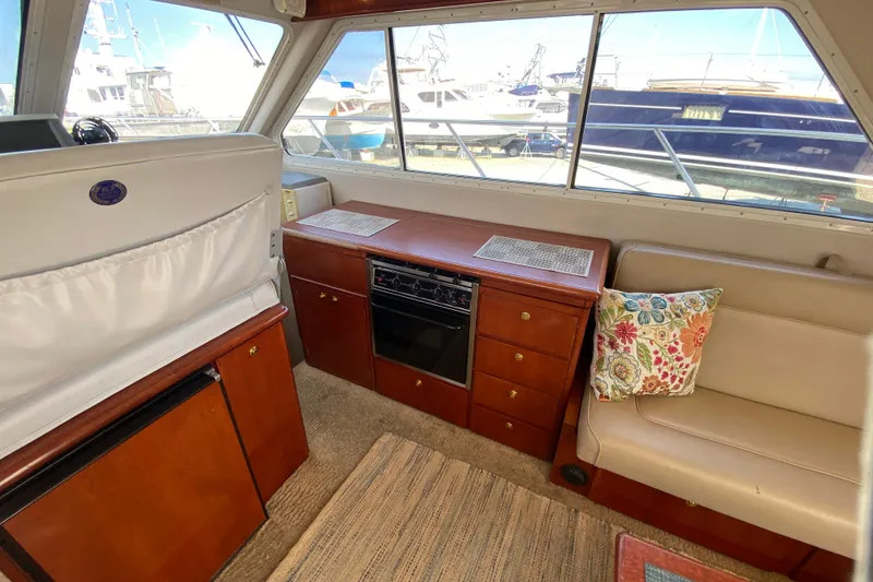 Slide: The Image of Interior of a 2003 Zeta 36 boat with seating, cabinetry, and nautical decor. - 13