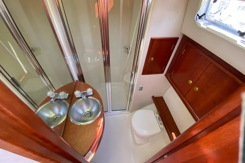 Slide: The Image of Luxurious bathroom in 2003 Zeta 36 yacht with dual sinks and wooden cabinetry. - 24