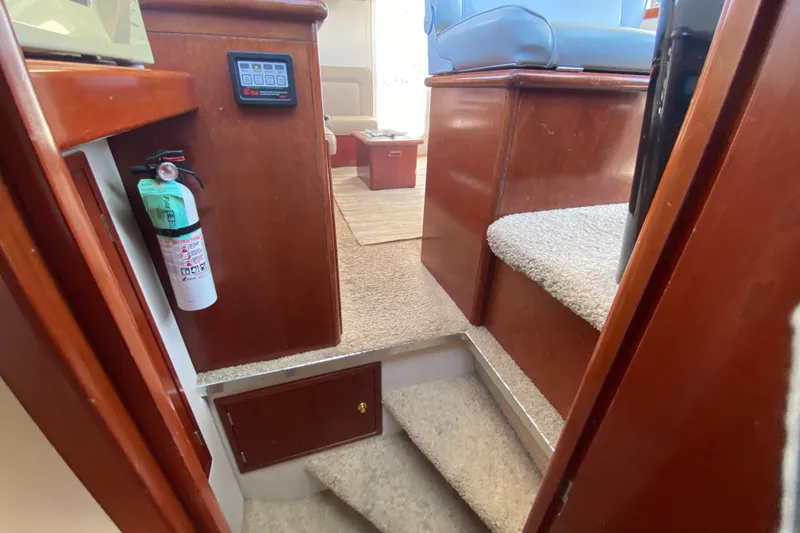 Slide: The Image of Interior of 2003 Zeta 36 boat with carpeted stairs and fire extinguisher. - 27