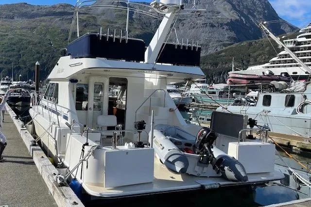 Slide: The Image of Zeta 36 yacht from 2003 docked at a marina with mountainous backdrop. - 3