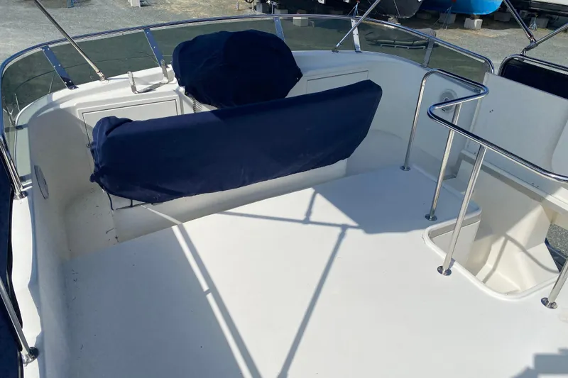 Slide: The Image of 2003 Zeta 36 boat interior with blue-covered seating and stainless steel railings. - 47