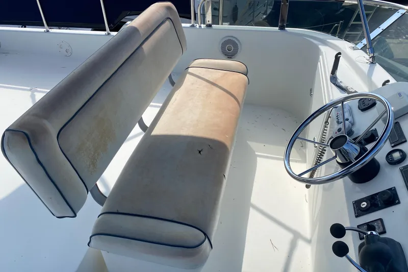 Slide: The Image of 2003 Zeta 36 boat cockpit with dual seats and steering wheel. - 50
