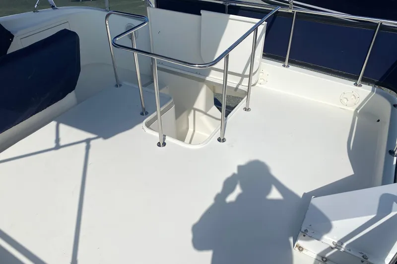 Slide: The Image of Deck of 2003 Zeta 36 boat with railing and shadow. - 52
