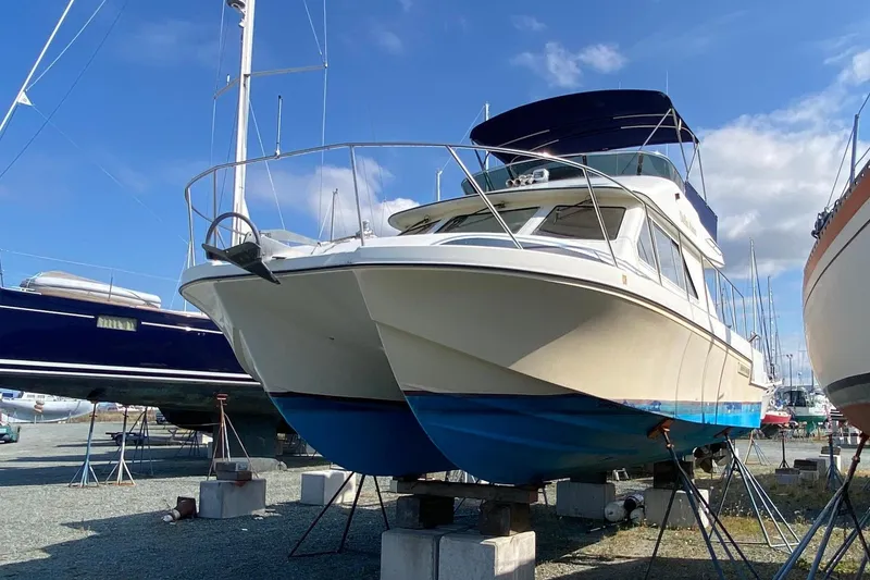 Slide: The Image of Boats in a marina, including a 2003 Zeta 36, under a clear blue sky. - 75