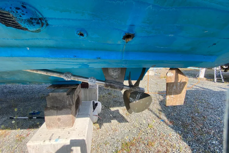 Slide: The Image of Bottom view of a 2003 Zeta 36 boat showing propeller and hull on dry dock. - 79