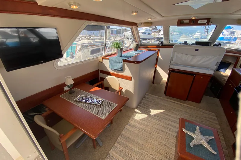 Slide: The Image of Luxurious interior of 2003 Zeta 36 yacht with dining area and scenic marina views. - 8