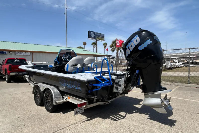 Slide: The Image of 2015 Haynie Magnum boat with powerful outboard motor in a parking lot. - 14