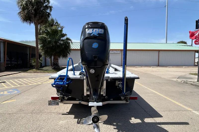 Slide: The Image of 2015 Haynie Magnum boat with powerful outboard motor in a parking lot. - 15