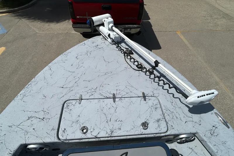 Slide: The Image of 2015 Haynie Magnum boat with trolling motor, parked behind a red Chevrolet Silverado. - 4