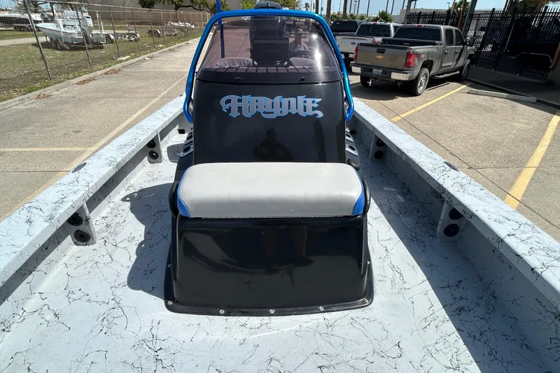 Slide: The Image of 2015 Haynie Magnum boat with custom seating and sleek design in a parking lot. - 5