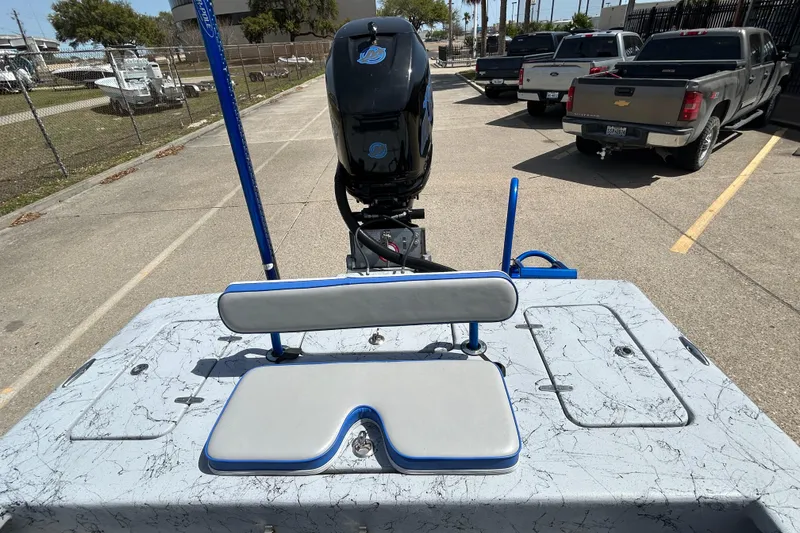 Slide: The Image of 2015 Haynie Magnum boat with motor, parked in a lot, featuring a marbled deck. - 6