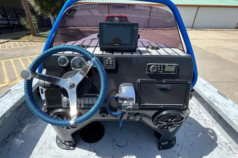 Slide: The Image of 2015 Haynie Magnum boat dashboard with steering wheel and navigation equipment. - 8