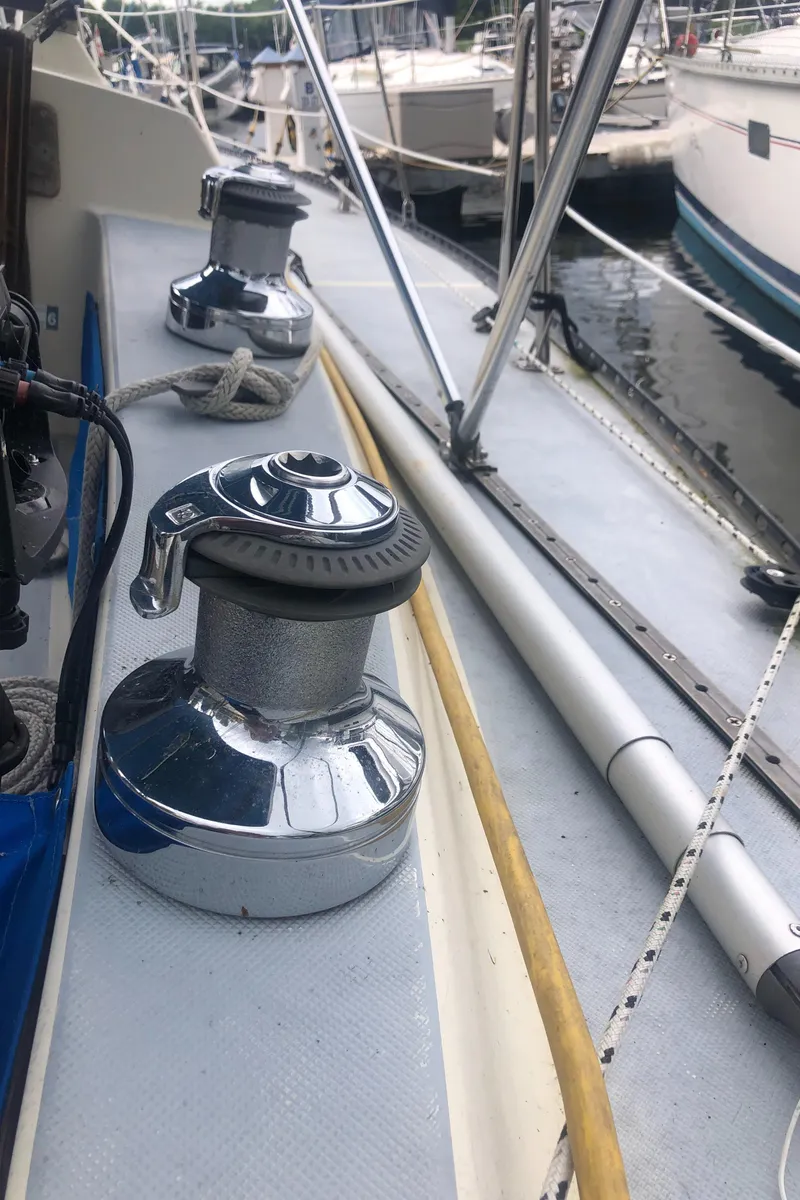 Slide: The Image of 1980 Lancer 36 sailboat deck with winches and rigging in a marina. - 13