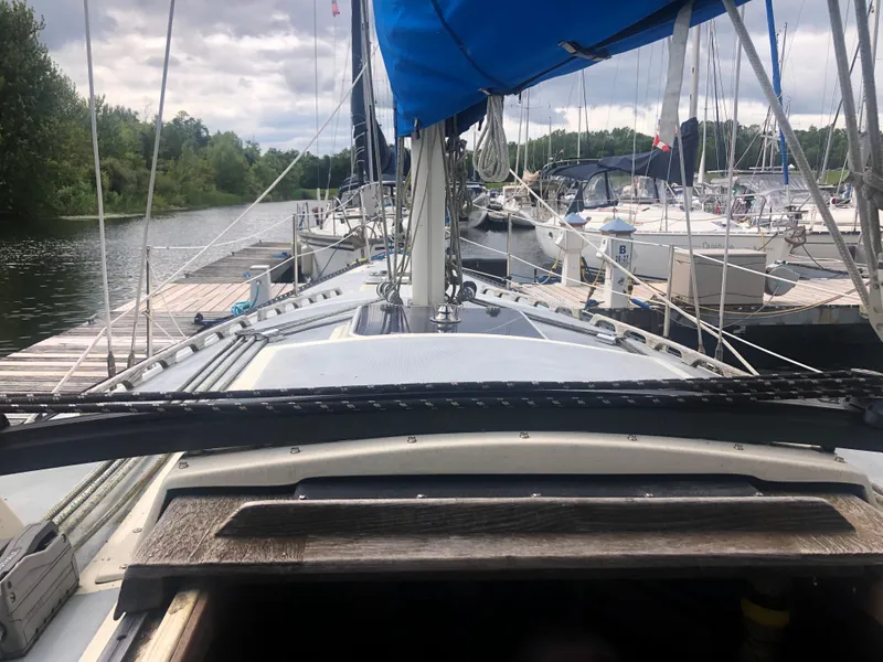 Slide: The Image of 1980 Lancer 36 sailboat docked at a marina, surrounded by other boats. - 15
