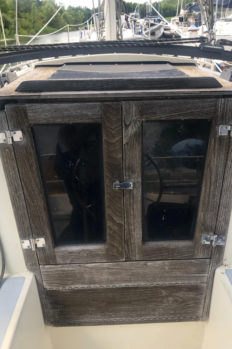 Slide: The Image of 1980 Lancer 36 sailboat cabin entrance with wooden doors and glass panels. - 16