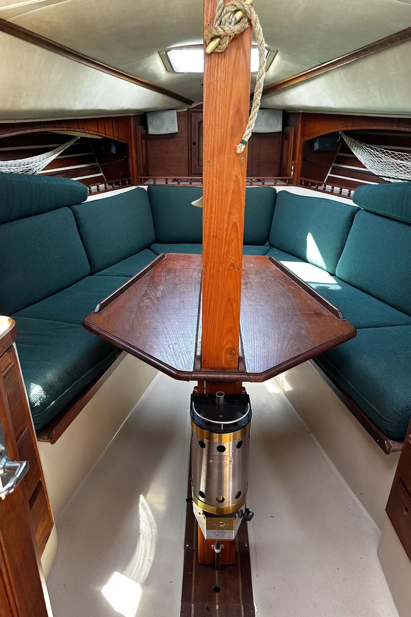 Slide: The Image of 1980 Lancer 36 yacht interior with wooden table and green seating. - 21