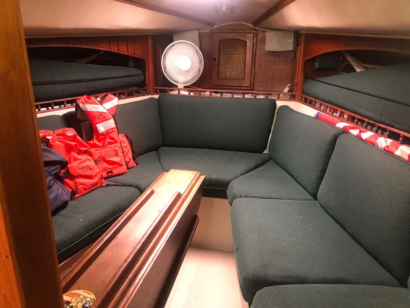Slide: The Image of Cozy interior of 1980 Lancer 36 sailboat with seating, life jackets, and fan. - 24
