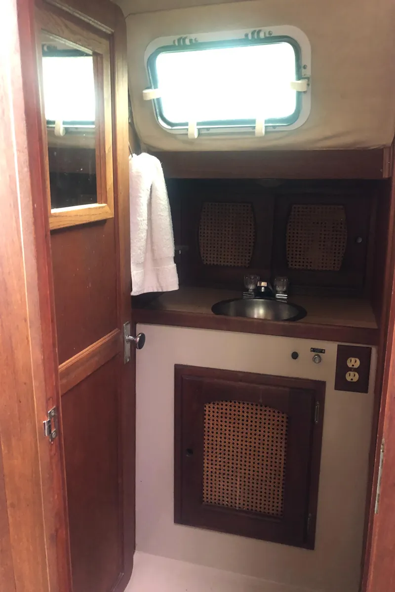 Slide: The Image of 1980 Lancer 36 yacht bathroom with wooden cabinetry and small sink. - 33