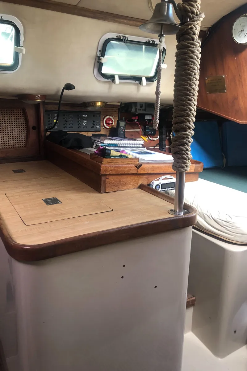 Slide: The Image of Interior of a 1980 Lancer 36 sailboat with wooden cabinetry and nautical decor. - 36