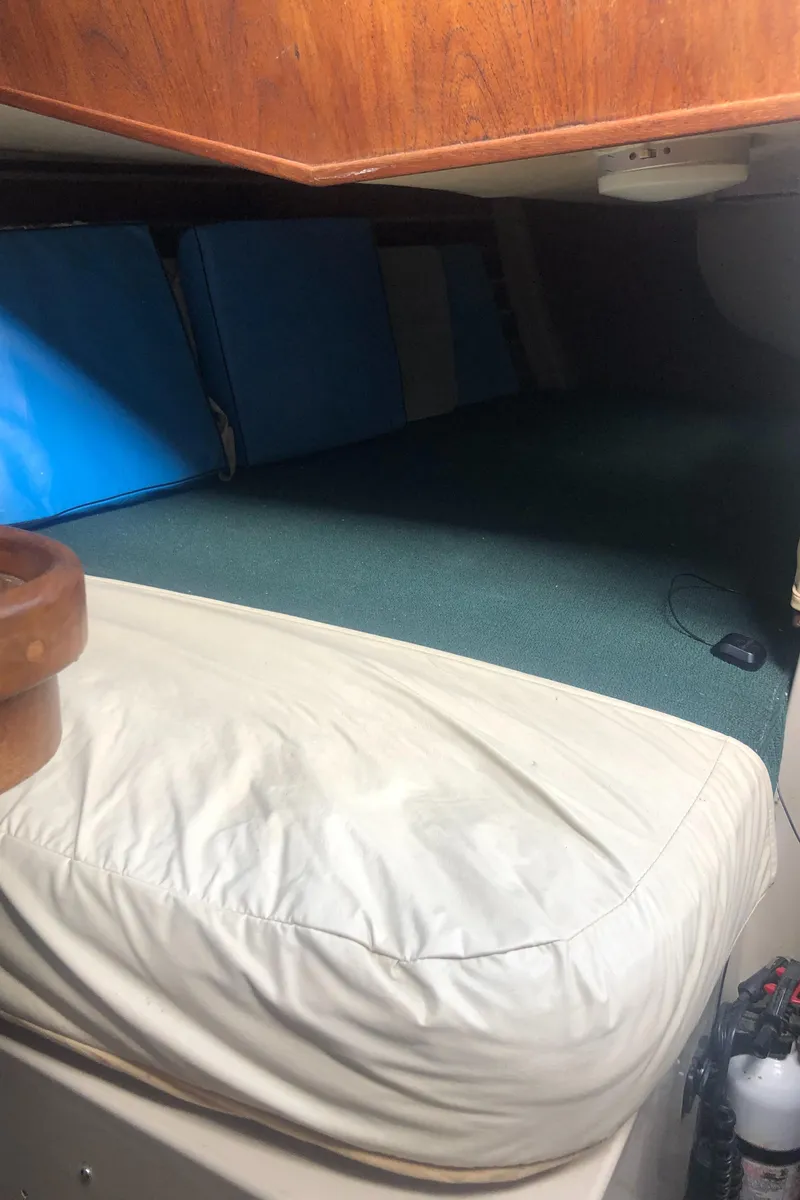 Slide: The Image of Interior cabin of a 1980 Lancer 36 sailboat with cushioned seating. - 38