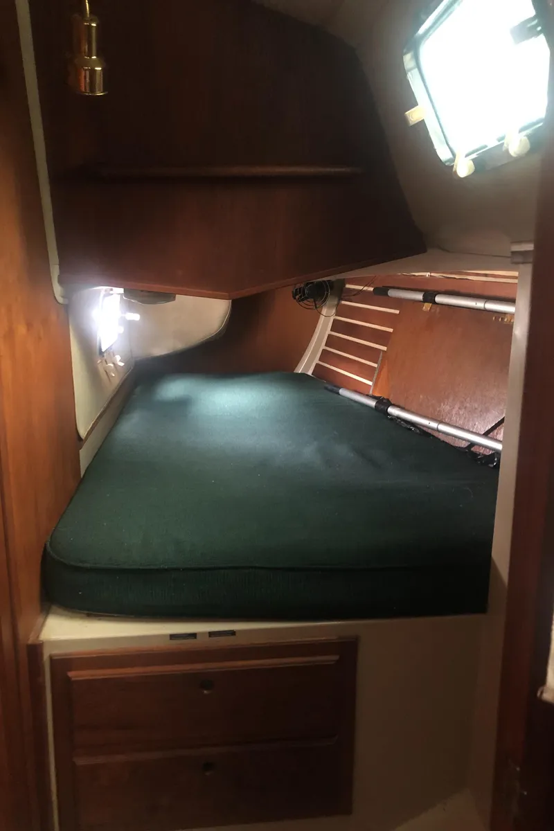 Slide: The Image of 1980 Lancer 36 yacht interior cabin with bed, wooden storage, and window. - 41
