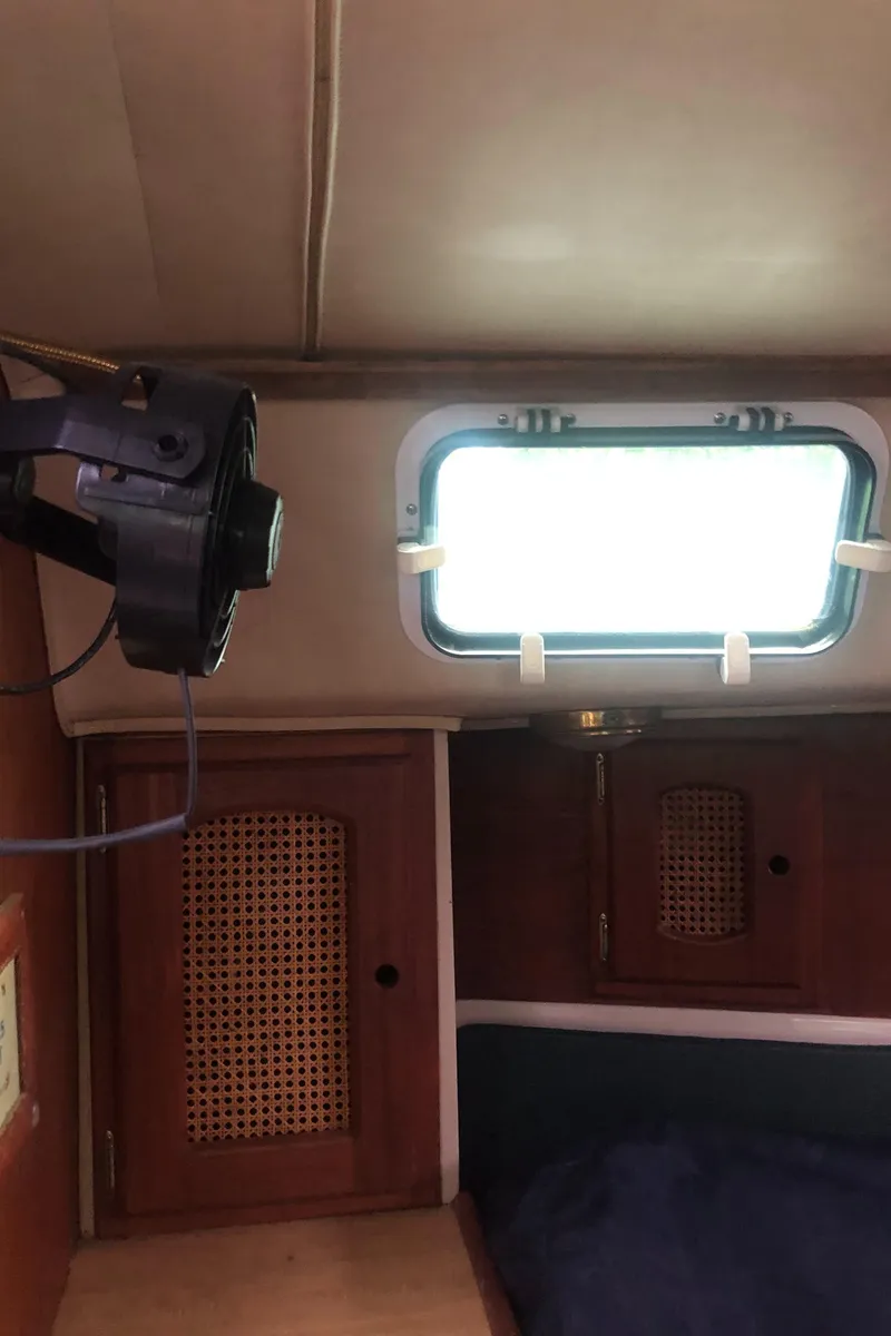 Slide: The Image of Interior of 1980 Lancer 36 sailboat cabin with window and wooden cabinets. - 45