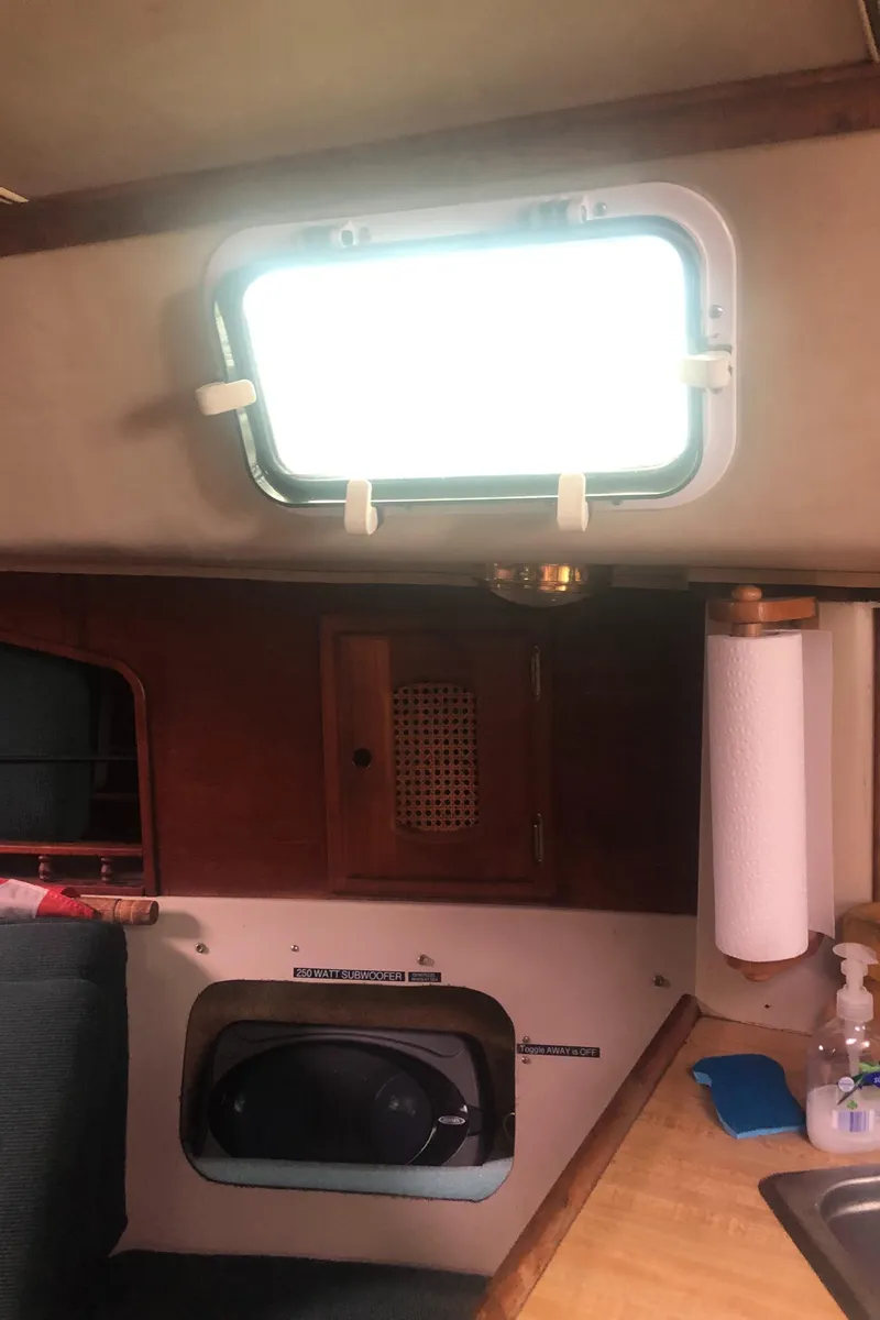Slide: The Image of Interior of a 1980 Lancer 36 sailboat with window, storage, and countertop. - 46