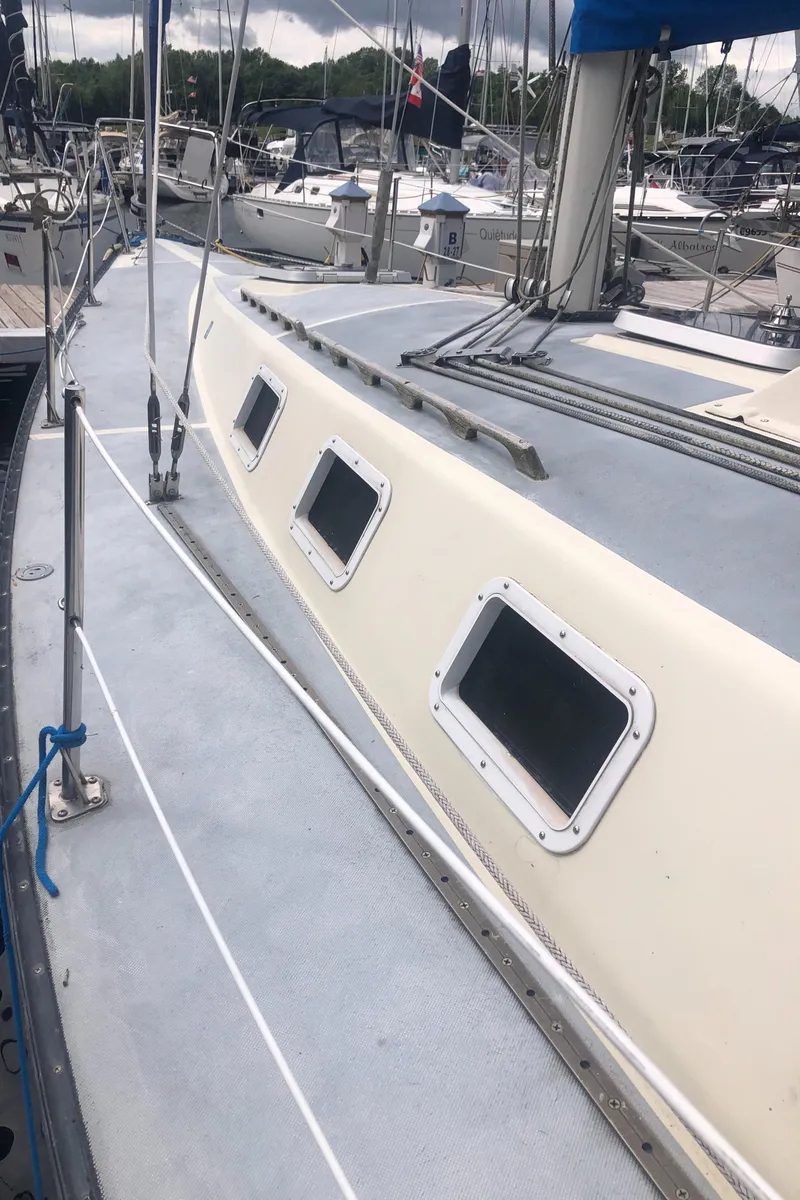 Slide: The Image of 1980 Lancer 36 sailboat deck with windows, docked in a marina. - 6
