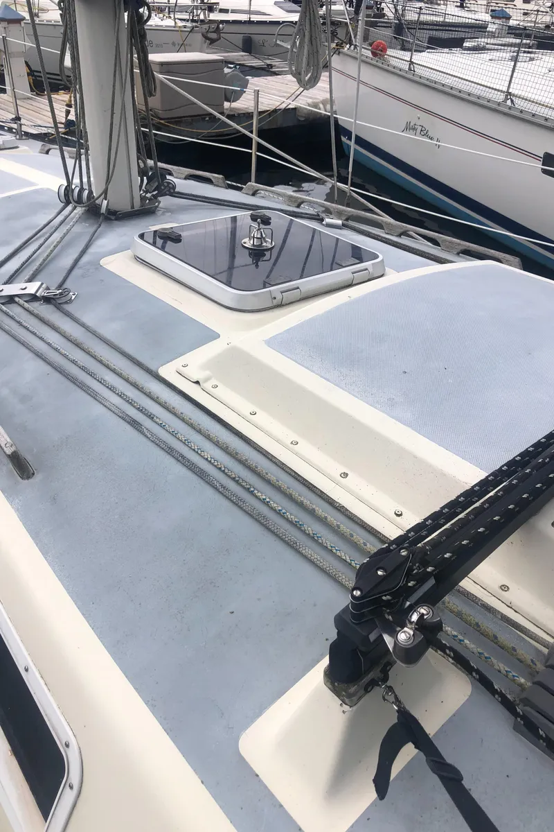 Slide: The Image of 1980 Lancer 36 sailboat deck with rigging and hatch, docked at marina. - 7