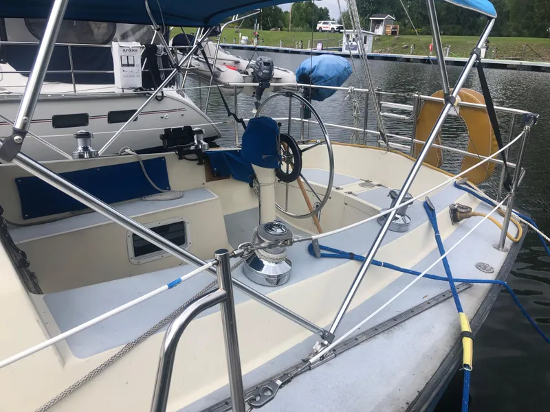 Slide: The Image of 1980 Lancer 36 sailboat cockpit with steering wheel, docked at marina. - 9