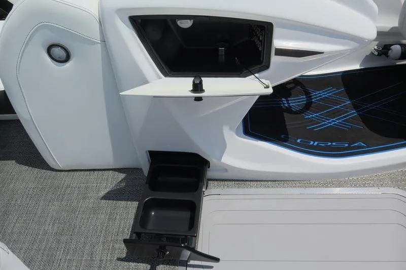 Slide: The Image of 2025 Barletta Corsa 23UC boat interior with storage compartments and cup holders. - 9