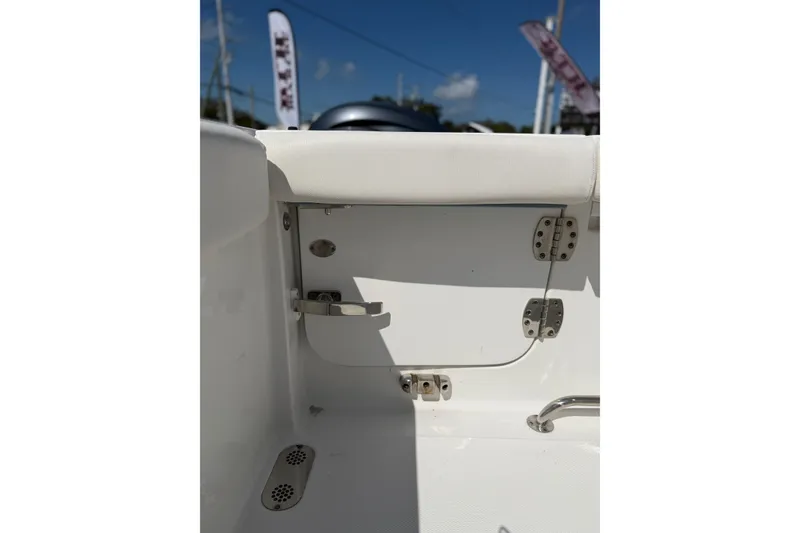 Slide: The Image of 2019 Sea Hunt Gamefish 27 boat interior detail with hinges and white upholstery. - 16