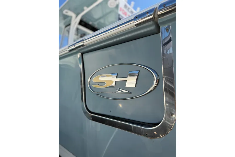 Slide: The Image of 2019 Sea Hunt Gamefish 27 boat emblem on a sleek blue surface. - 17