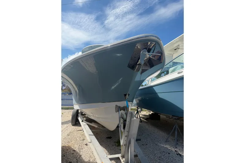 Slide: The Image of 2019 Sea Hunt Gamefish 27 boat on trailer under blue sky. - 2