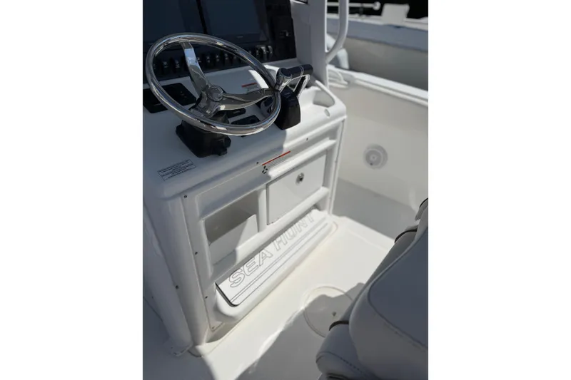 Slide: The Image of 2019 Sea Hunt Gamefish 27 boat helm with steering wheel and console. - 9