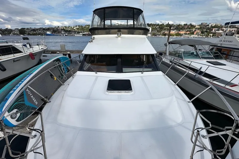 Slide: The Image of 1993 Ocean Alexander 460 yacht docked with paddleboard, scenic waterfront view. - 30