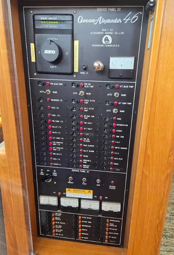 Slide: The Image of Electrical service panel of a 1993 Ocean Alexander 460 yacht, featuring switches and gauges. - 41