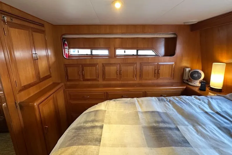 Slide: The Image of Cozy 1993 Ocean Alexander 460 yacht cabin with wooden cabinetry and soft lighting. - 56