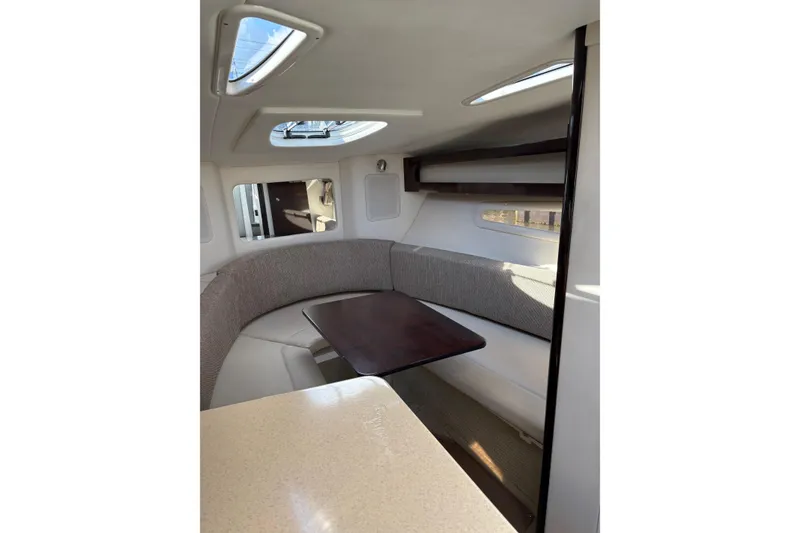 Slide: The Image of Interior of 2016 Sea Ray Sundancer 260 with cozy seating and table. - 4