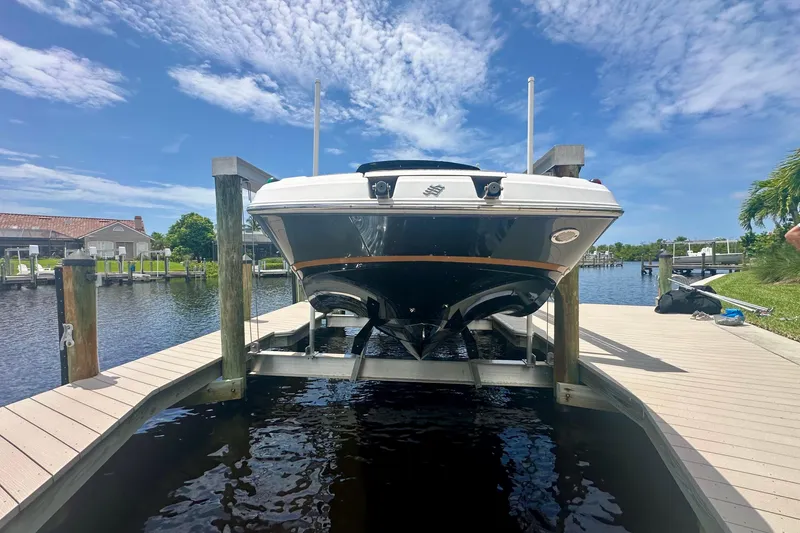Slide: The Image of 2019 Four Winns HD270 OB boat docked on a sunny day with blue skies. - 23