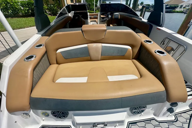 Slide: The Image of 2019 Four Winns HD270 OB boat with tan and gray seating, cup holders, and sleek design. - 5