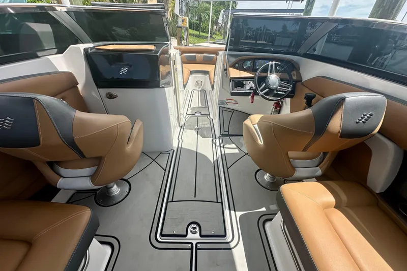 Slide: The Image of 2019 Four Winns HD270 OB boat interior with tan and black seating, sleek design. - 8