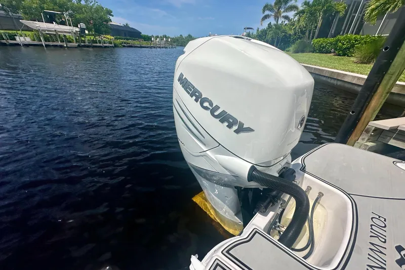 Slide: The Image of 2019 Four Winns HD270 OB with Mercury outboard engine docked by a canal. - 17