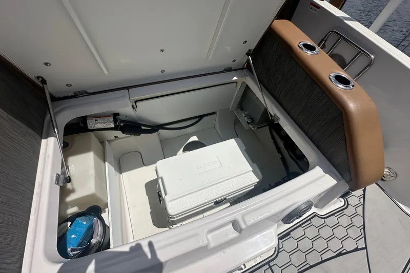 Slide: The Image of 2019 Four Winns HD270 OB boat storage compartment with cooler and accessories. - 18