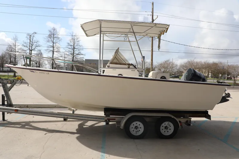 Slide: The Image of 2002 Cape Craft 210 Center Console boat on trailer, parked outdoors. - 3