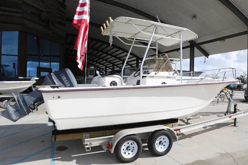 Slide: The Image of 2002 Cape Craft 210 Center Console boat on trailer with Yamaha outboard motor. - 7
