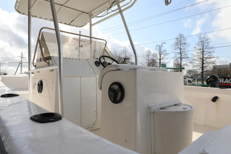 Slide: The Image of 2002 Cape Craft 210 Center Console boat interior with steering wheel and seating. - 8